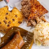 Papi’s Puerto Rican plate with rice, roasted meat, pastel and salad
